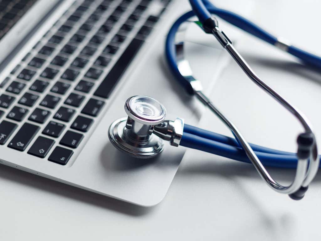 Close up of a blue stethoscope on a laptop.